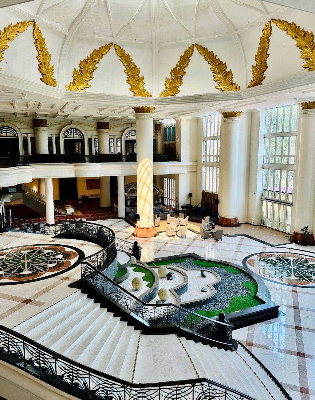 Luxurious hotel interior showcasing a grand staircase and elegant design elements.