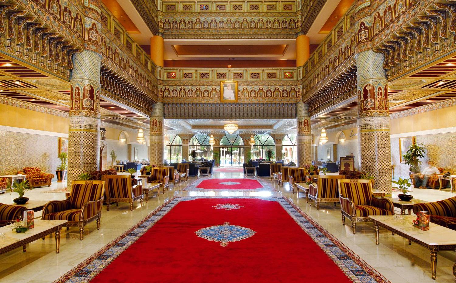 Luxurious Moroccan-inspired hotel lobby with intricate decorations and vibrant colors.