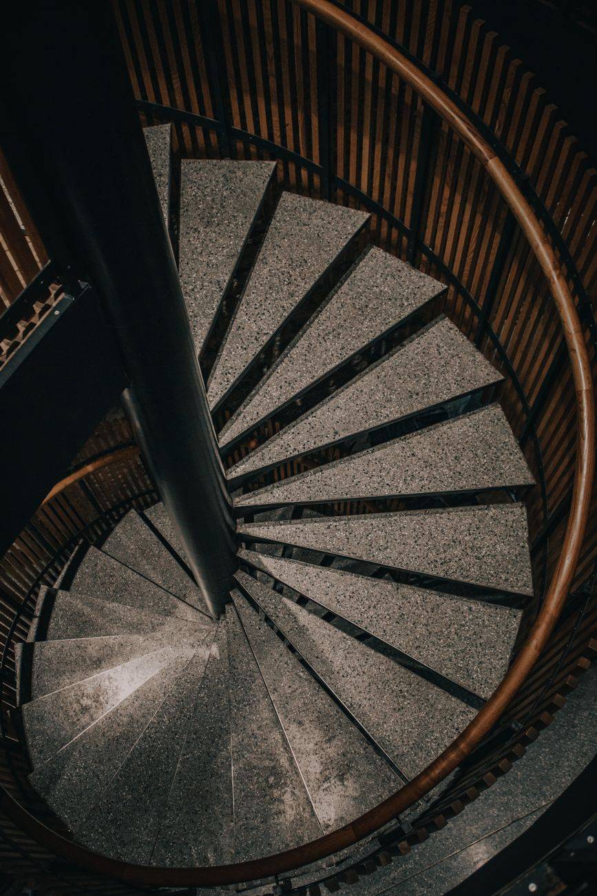 High angle view of a winding spiral staircase in modern architecture.