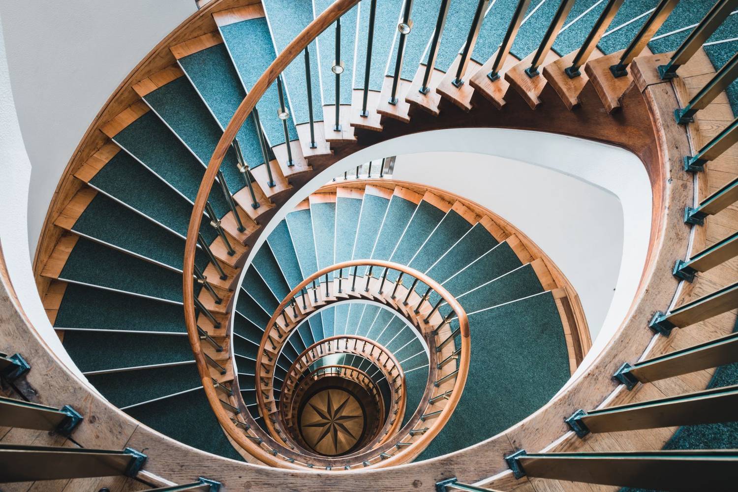 Intricate spiral staircase in Hamburg, showcasing elegant architectural design and geometry.