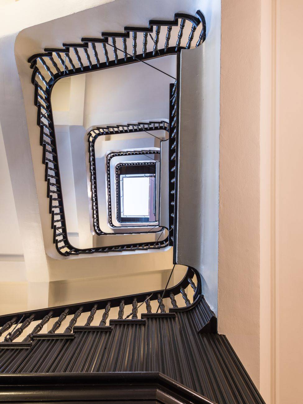 A mesmerizing view of a spiral staircase in a historic building in Hamburg, Germany.