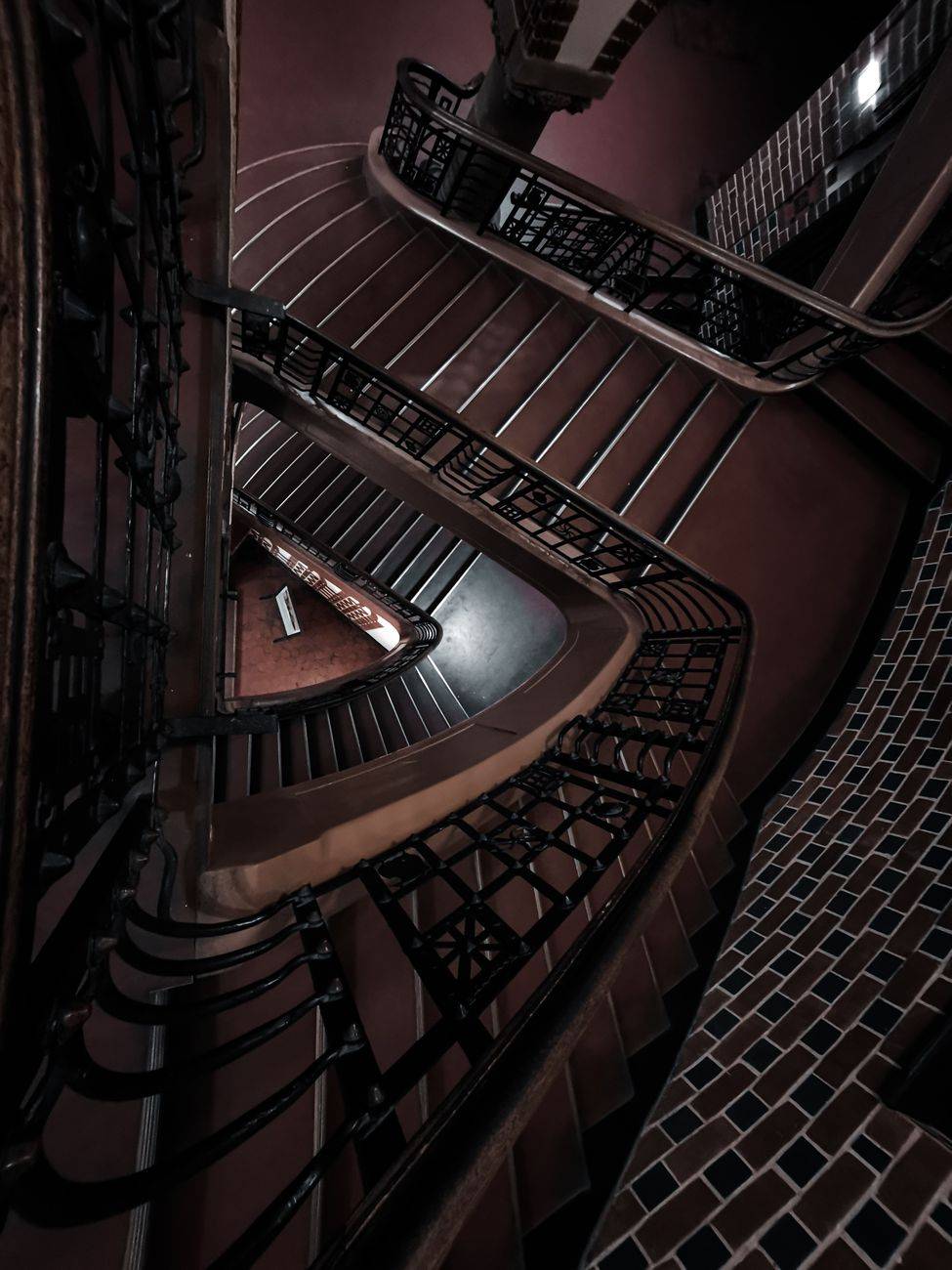 Captivating view of a spiral staircase with intricate metal railings indoors.