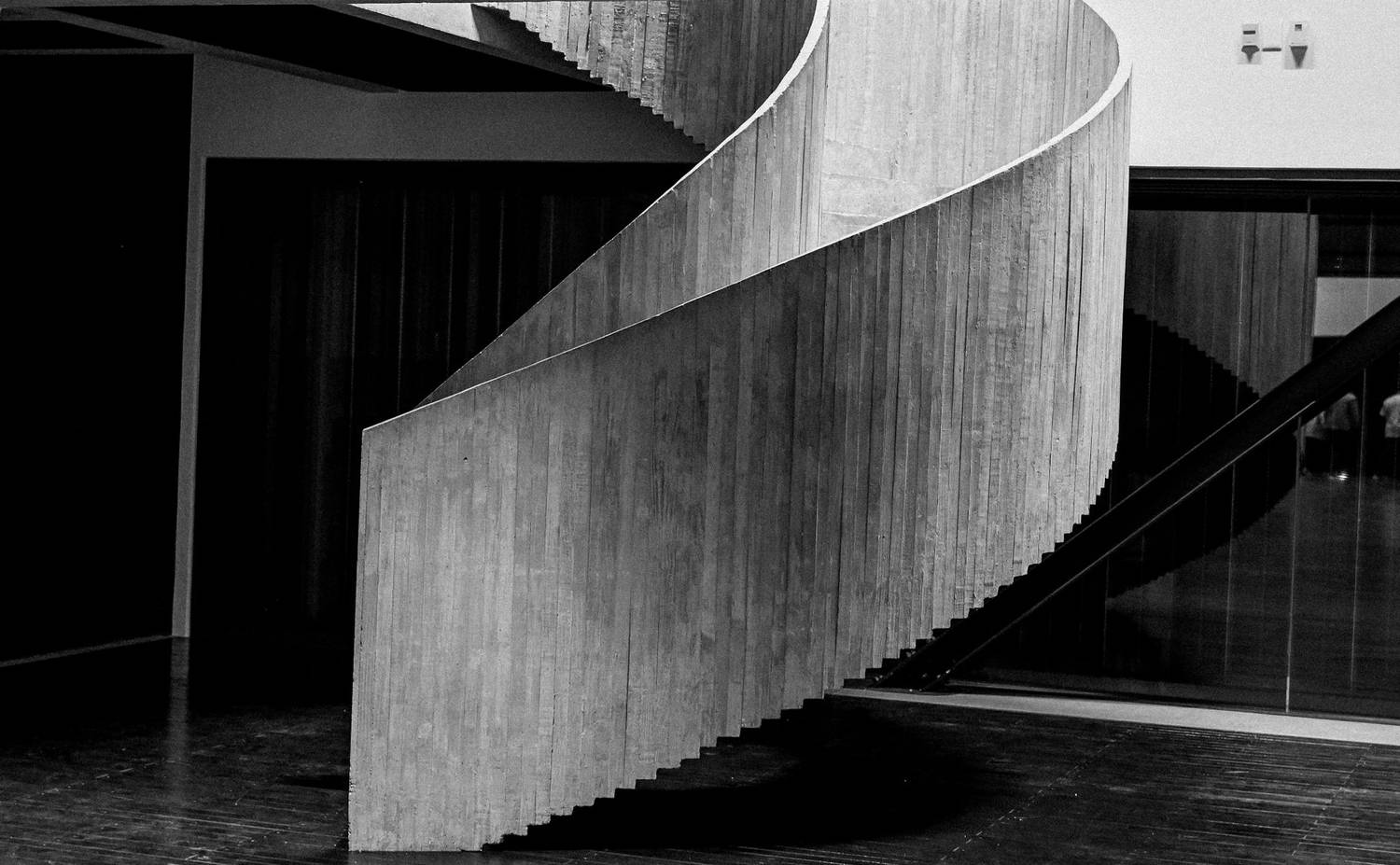 Minimalist spiral staircase in a modern interior, black and white.