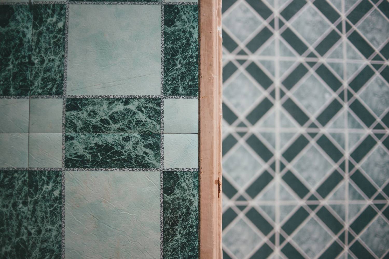 Detailed close-up of green and white patterned ceramic tiles, perfect for interior design inspiration.