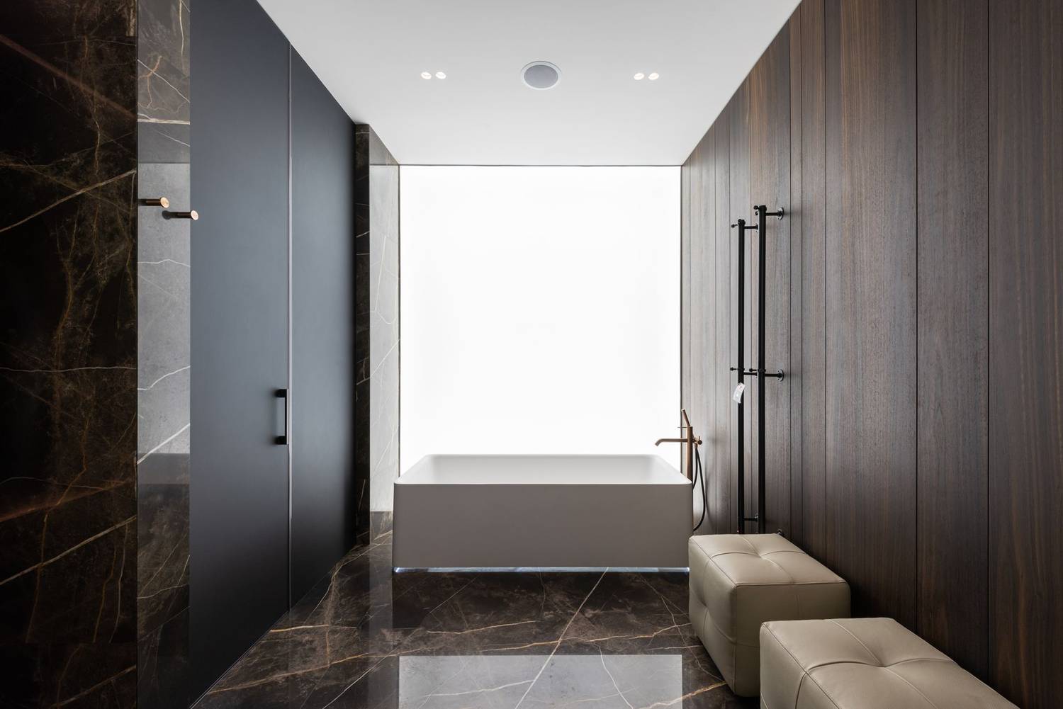Interior design of spacious bathroom in modern style with white leather poufs placed near wall