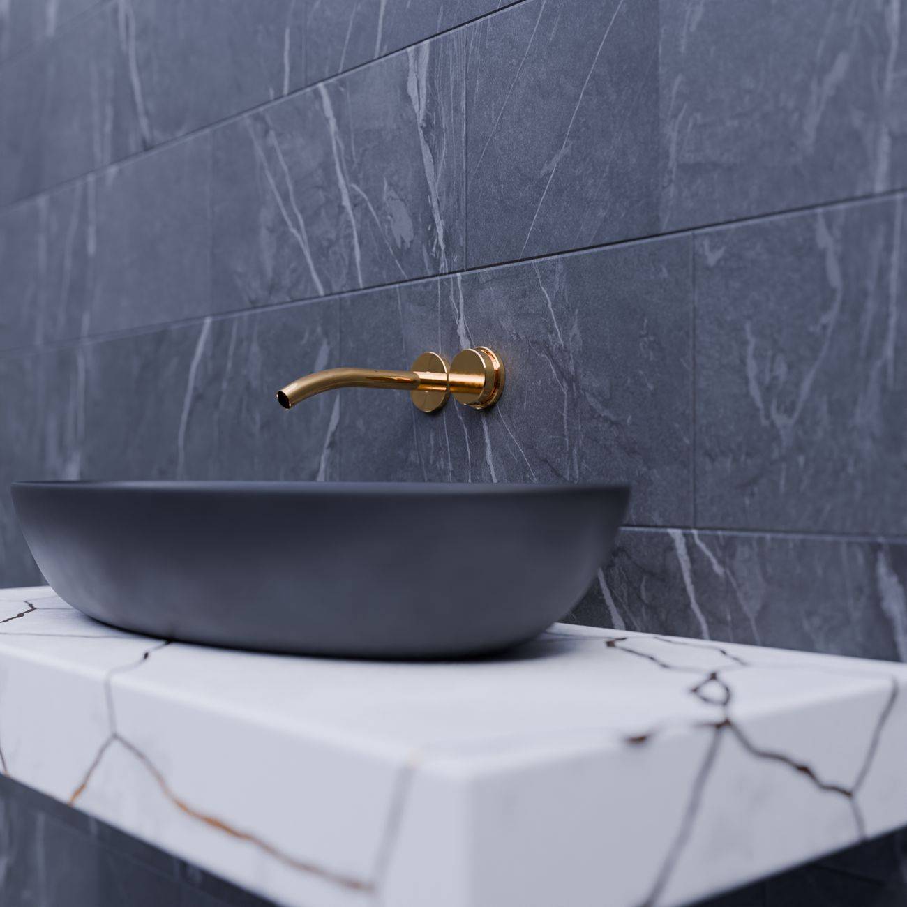 Elegant bathroom sink with gold faucet on marble slab and gray tiles.