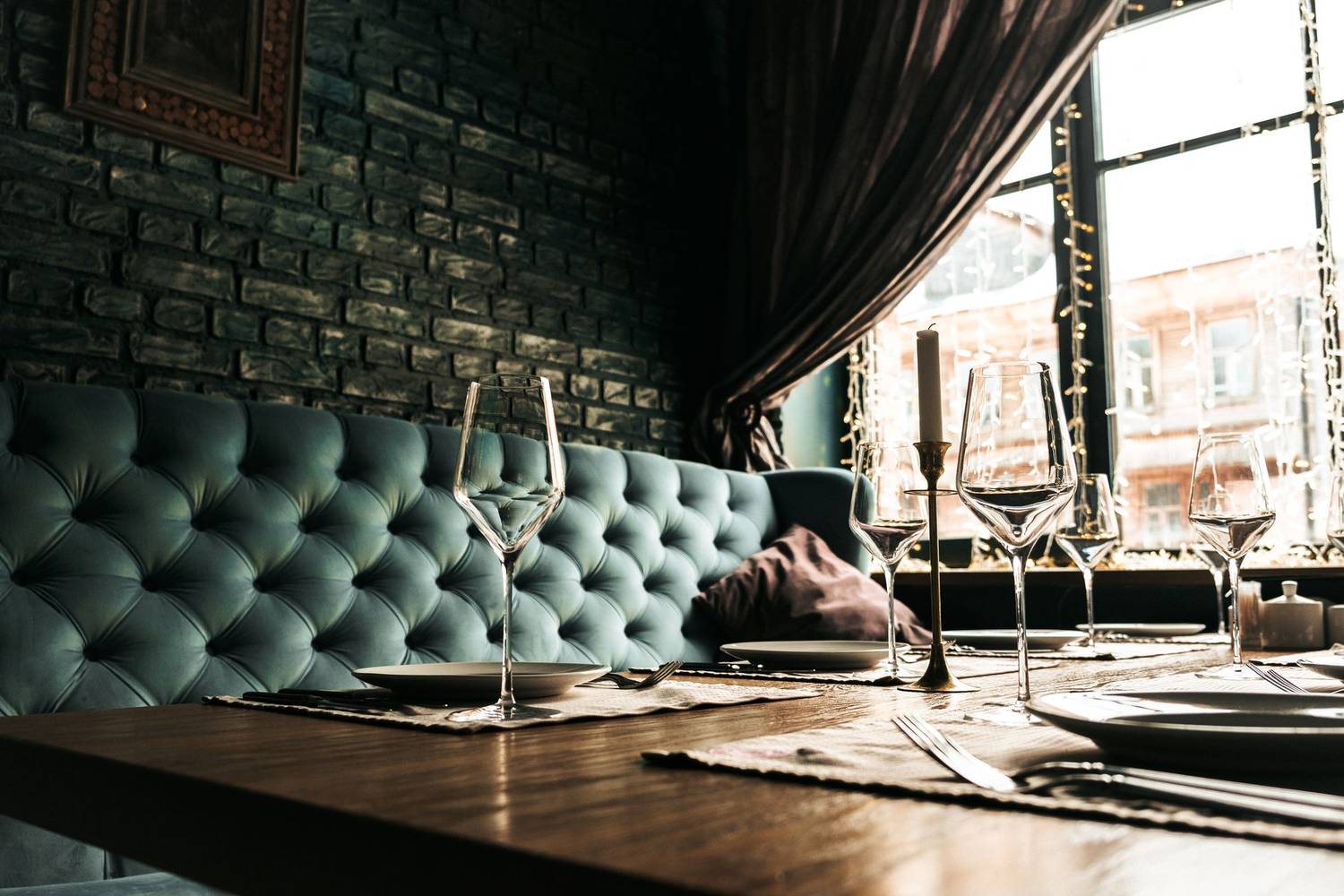 Sophisticated dining table with wine glasses and cutlery in a stylish restaurant.