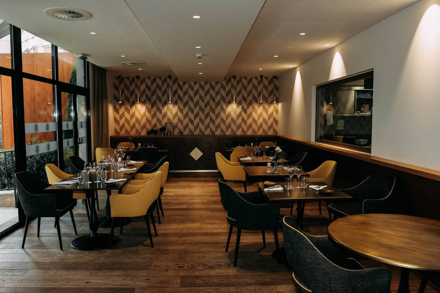 Stylish restaurant interior featuring modern decor, elegant furniture, and well-set dining tables.