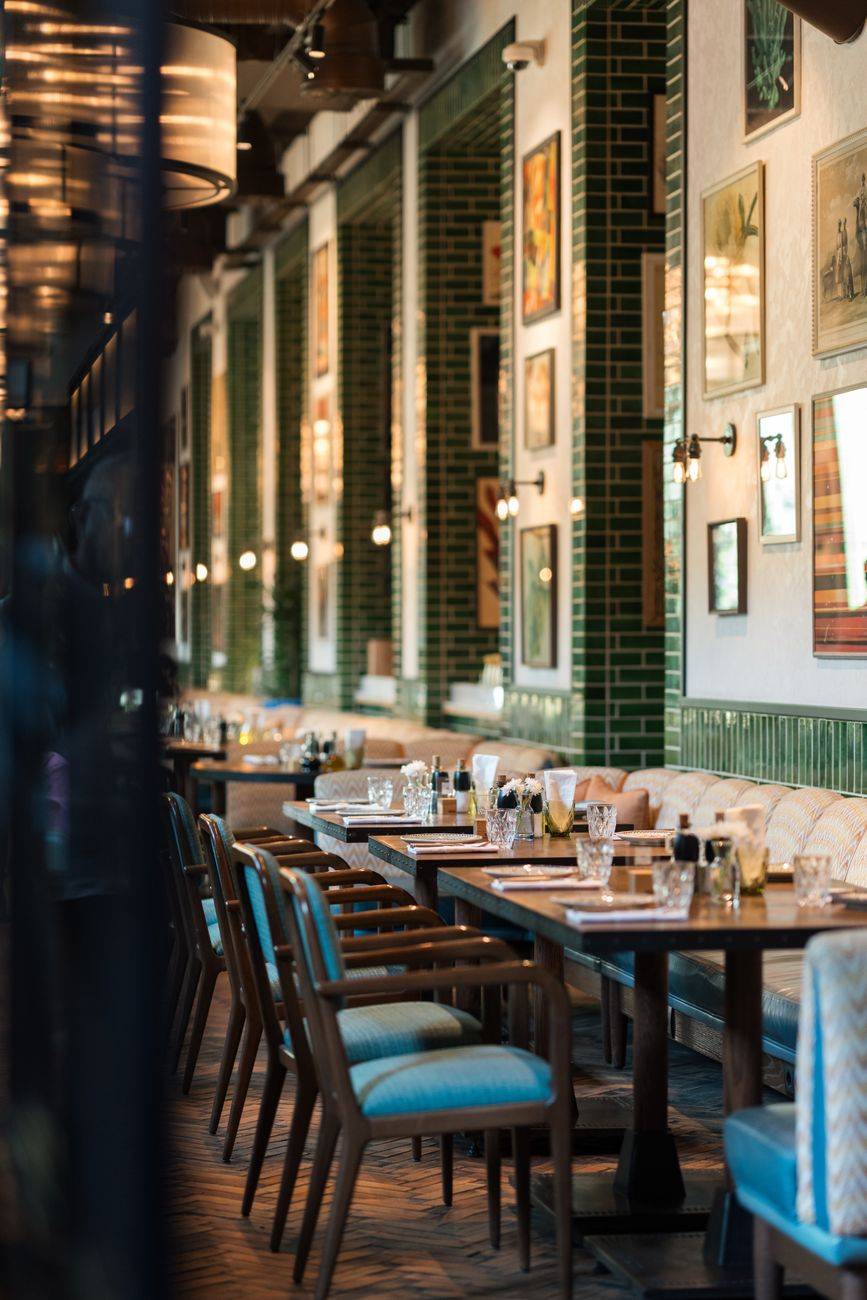 Stylish restaurant setting featuring elegant tables, chairs, and wall decor.