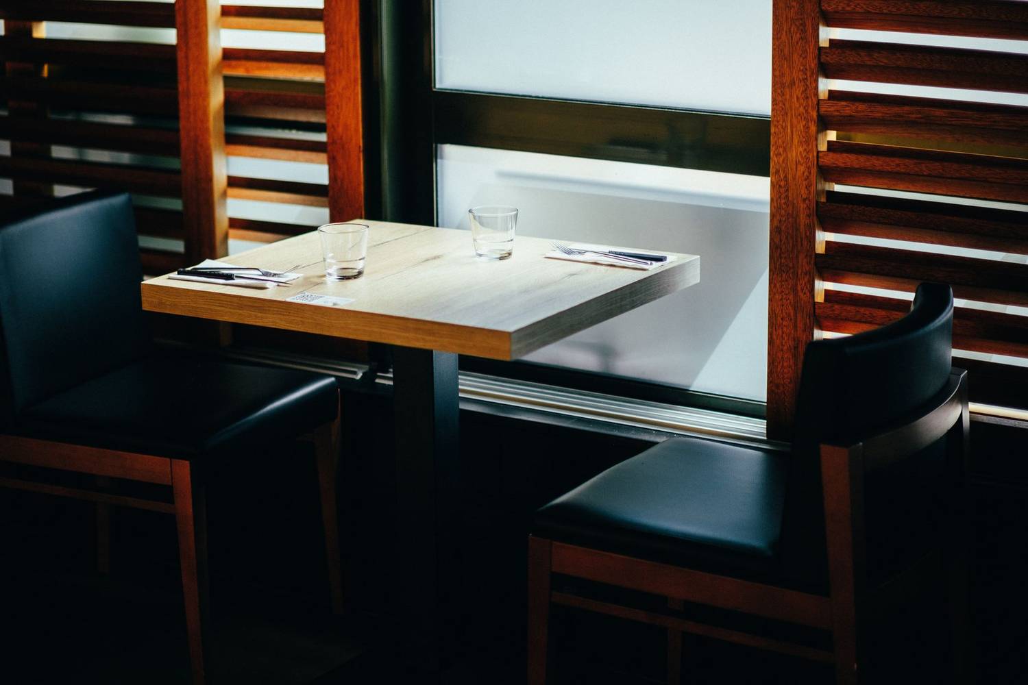 A stylish dining setup with a wooden table and chairs, perfect for a cozy meal.