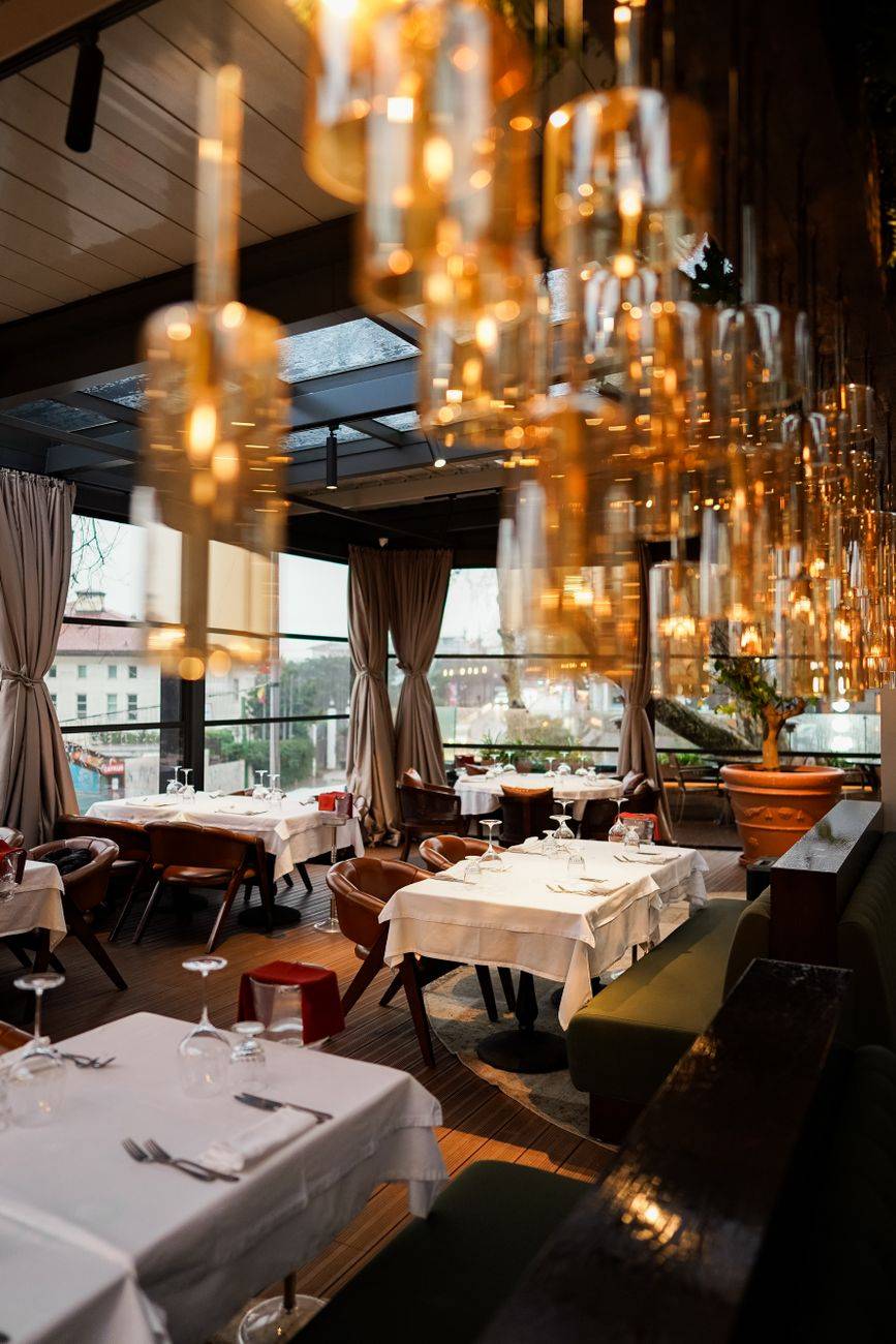 Explore the luxurious ambiance of an Istanbul restaurant with elegant decor and warm lighting.