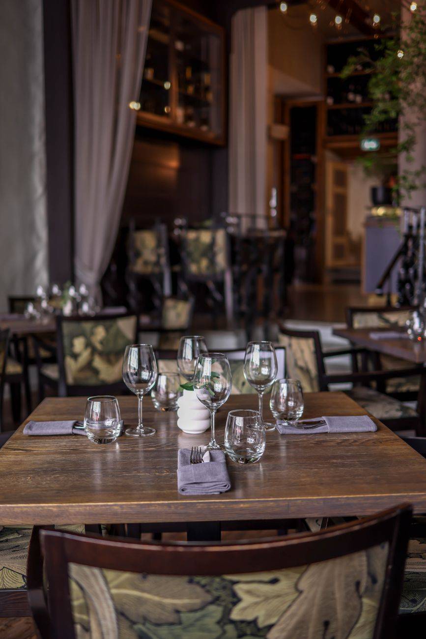 Cozy restaurant interior with elegant table setting, perfect for a luxury dining experience.