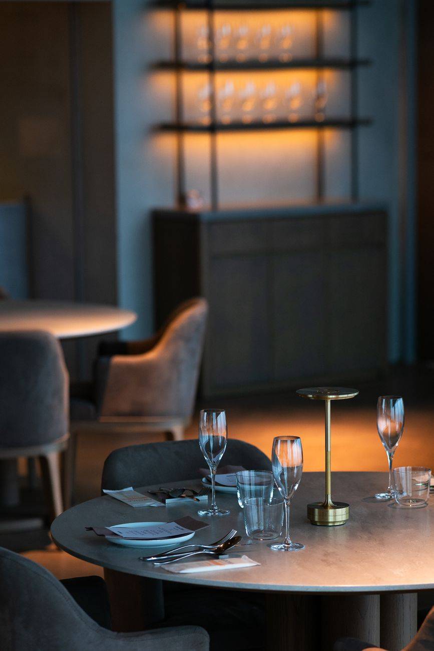 Cozy and elegant restaurant interior in Tokyo with stylish table setting and warm lighting.