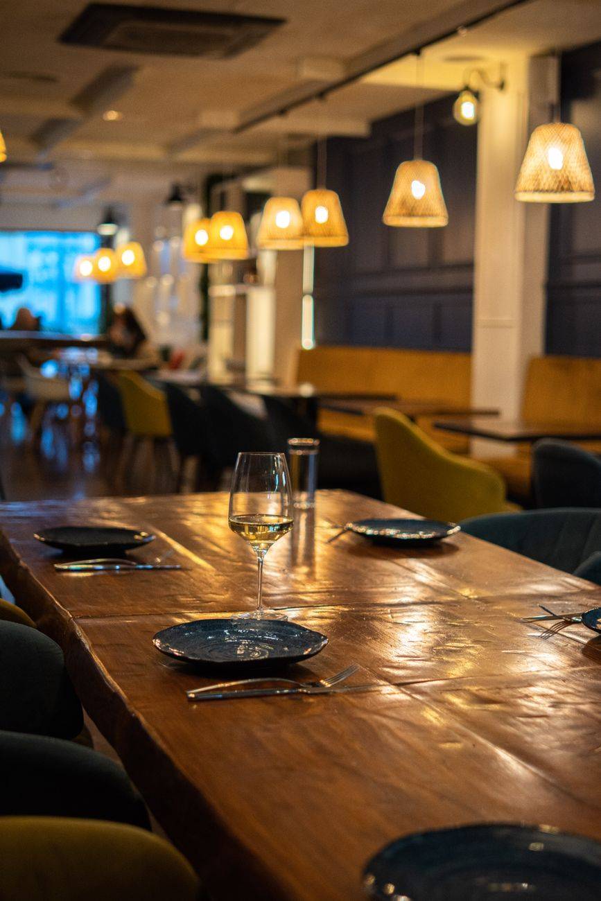 Elegant dining setting in a Barcelona restaurant with soft lighting and modern decor.