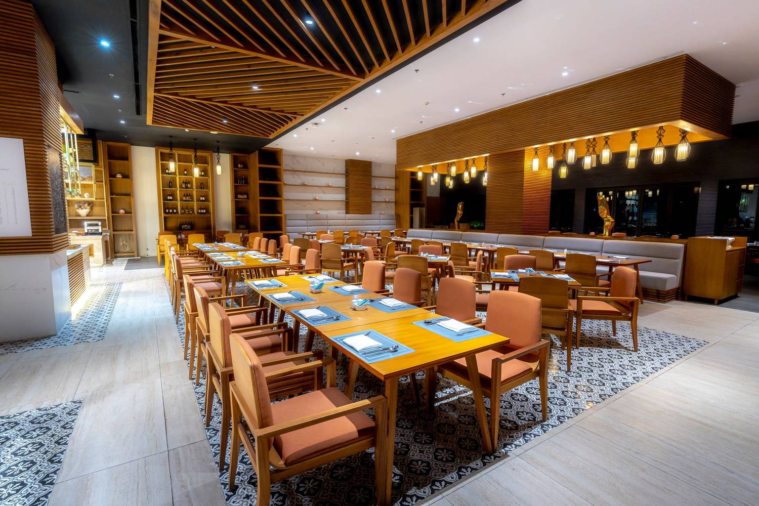 Modern restaurant interior with wooden furnishings and warm lighting.