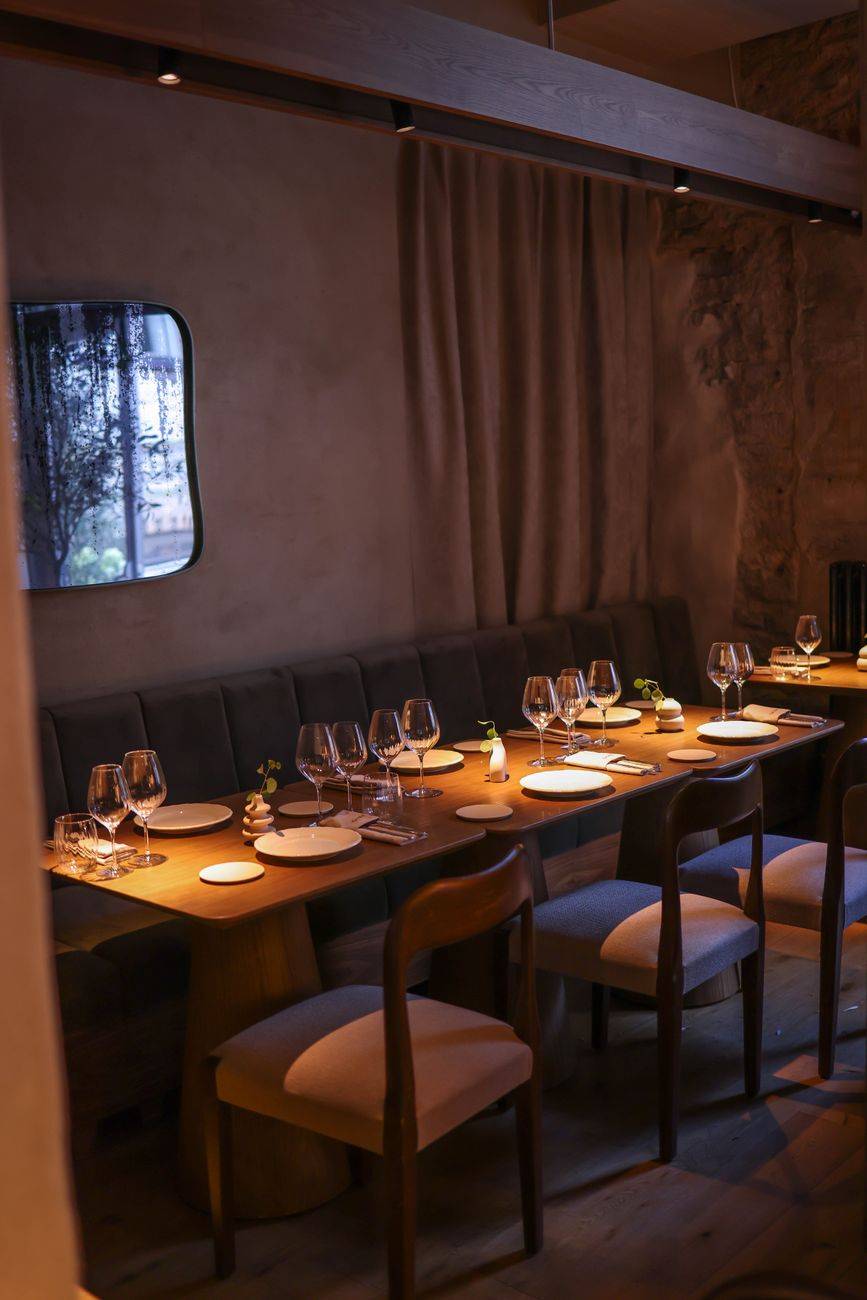 Cozy dining room featuring luxurious table setting and ambient lighting.