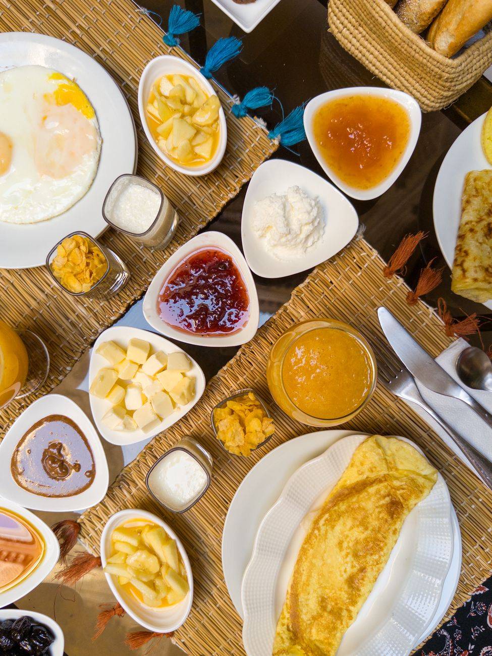 A mouthwatering continental breakfast spread with eggs, jam, butter, and cheese served elegantly on a table.