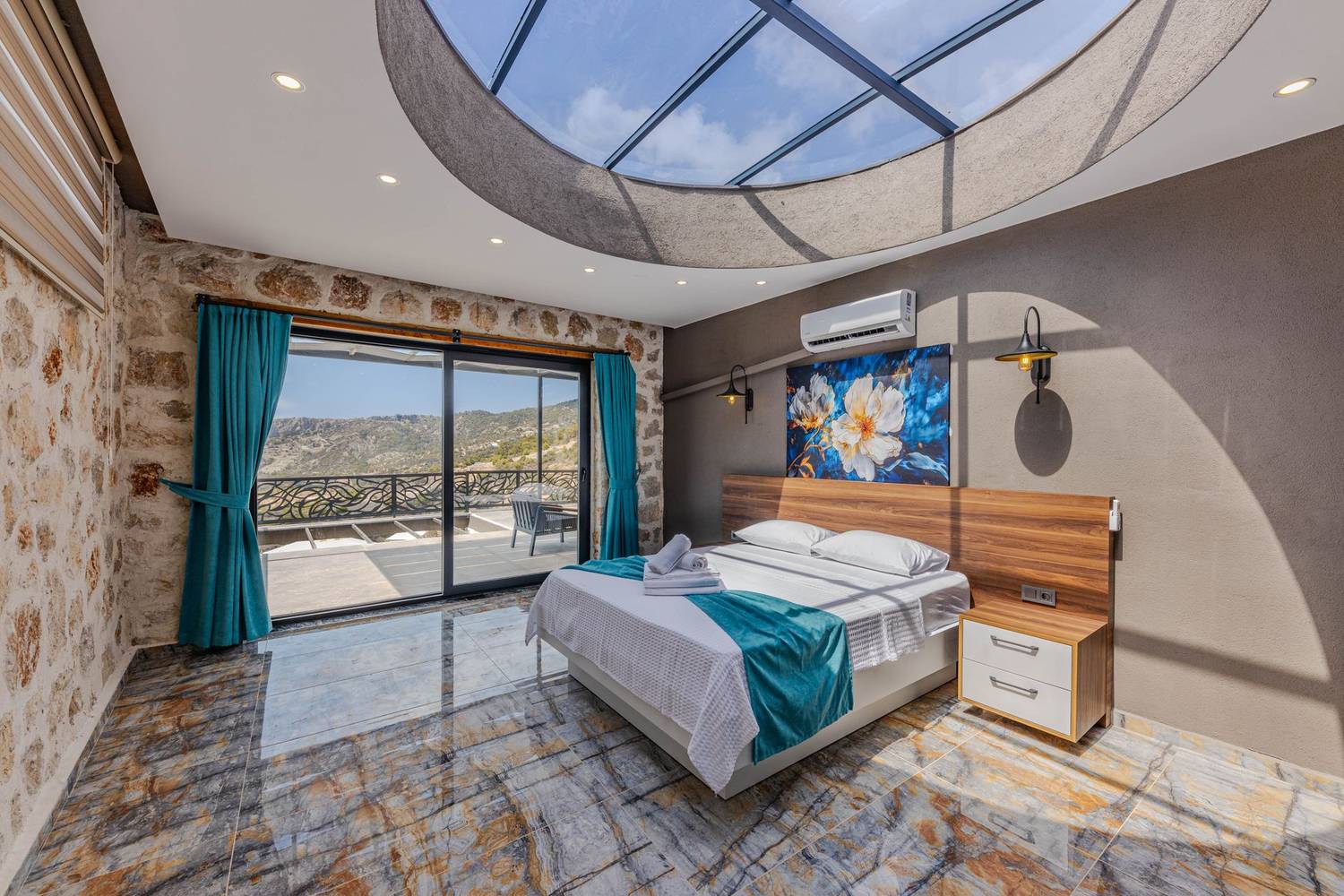 Contemporary bedroom design featuring bright skylight and scenic outdoor view.