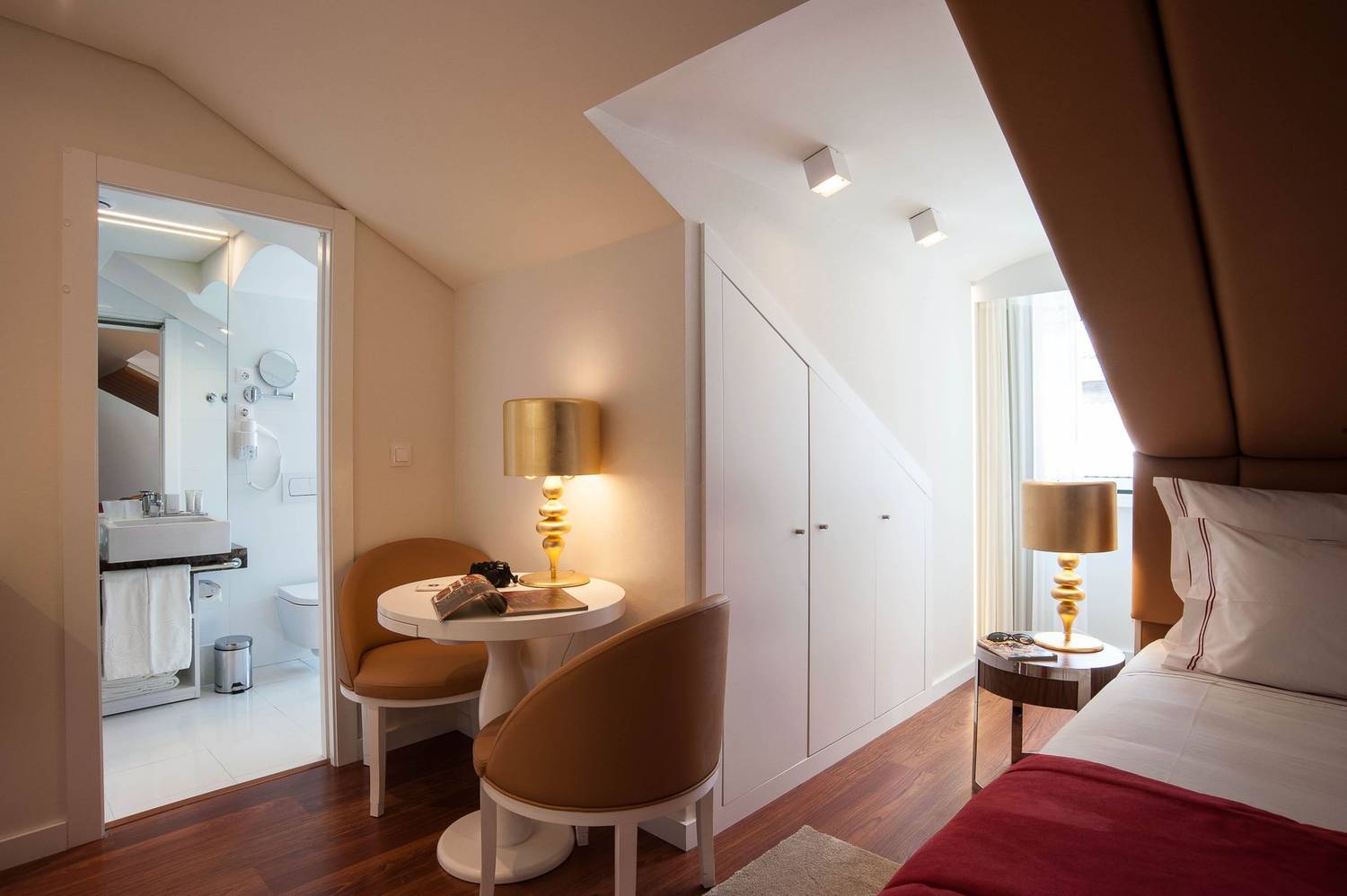 Stylish hotel room interior with modern furniture and warm lighting in Lisbon.