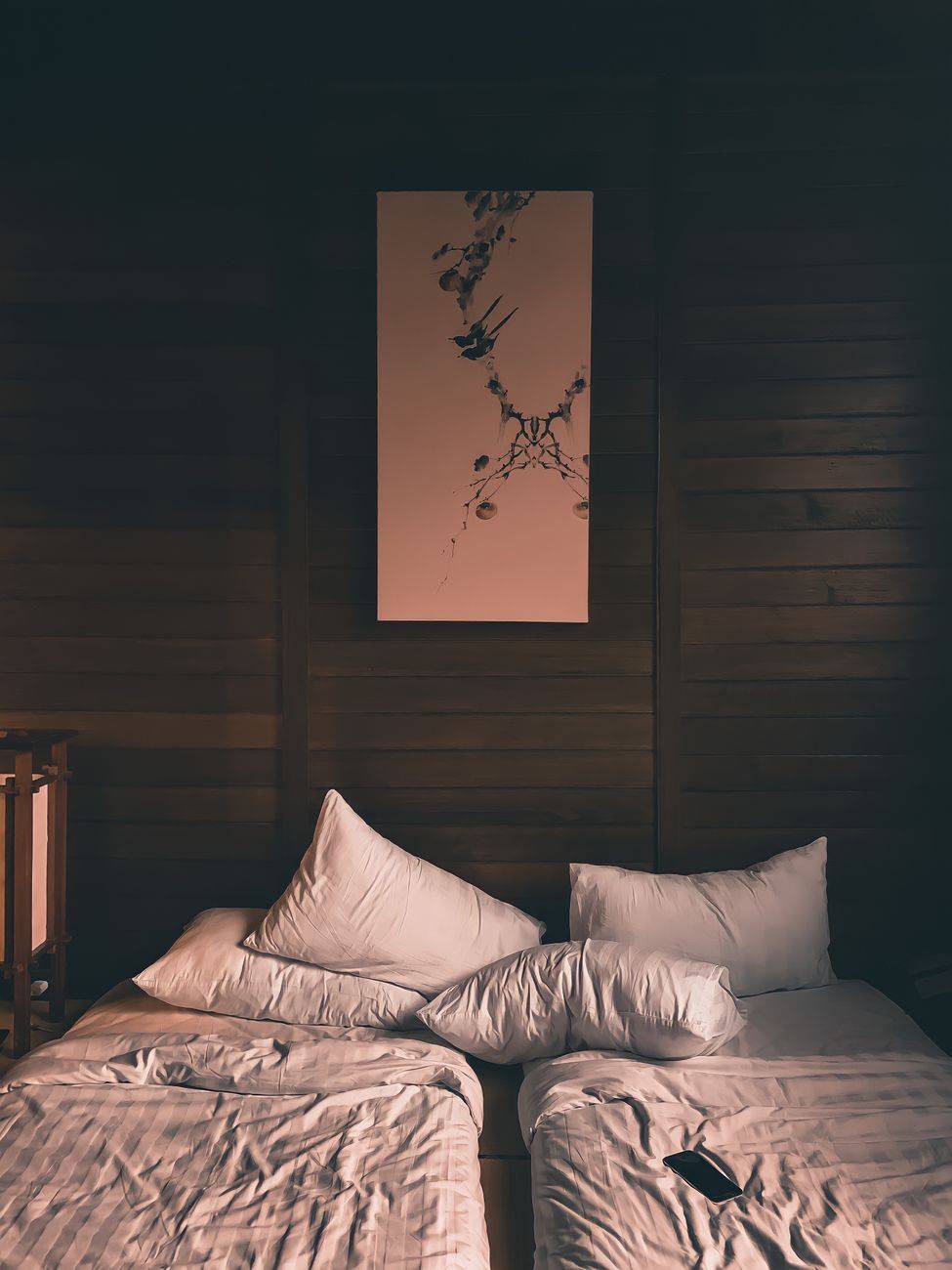 Tranquil wooden bedroom interior with art decor in Batu, East Java.