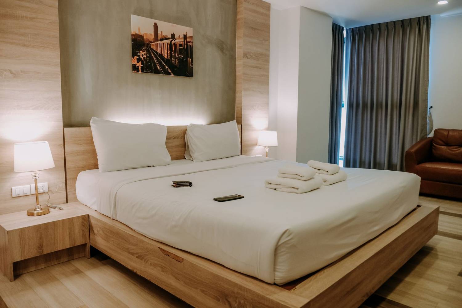 A warm and cozy modern bedroom featuring a large comfortable bed with soft lighting, perfect for relaxation.