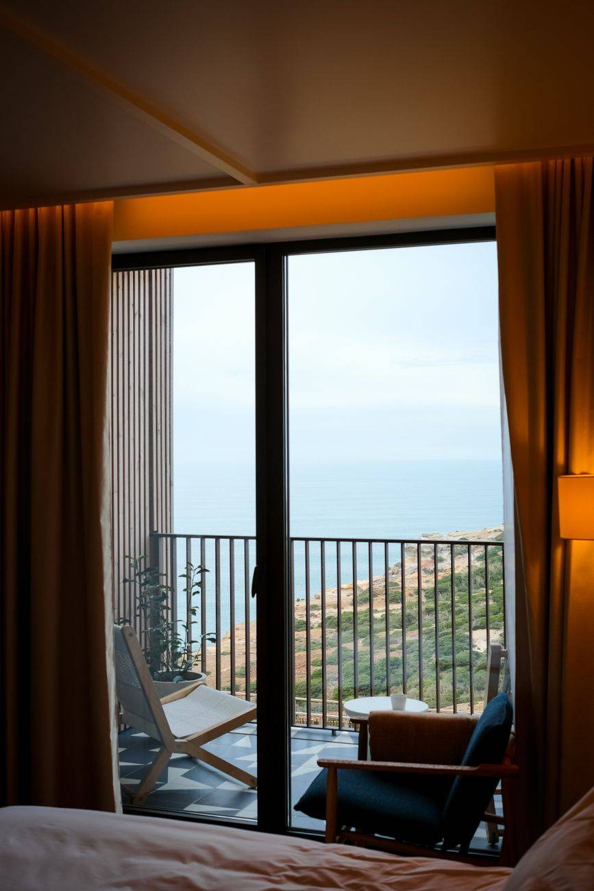 Serene coastal view from a hotel room balcony in Ericeira, Portugal.