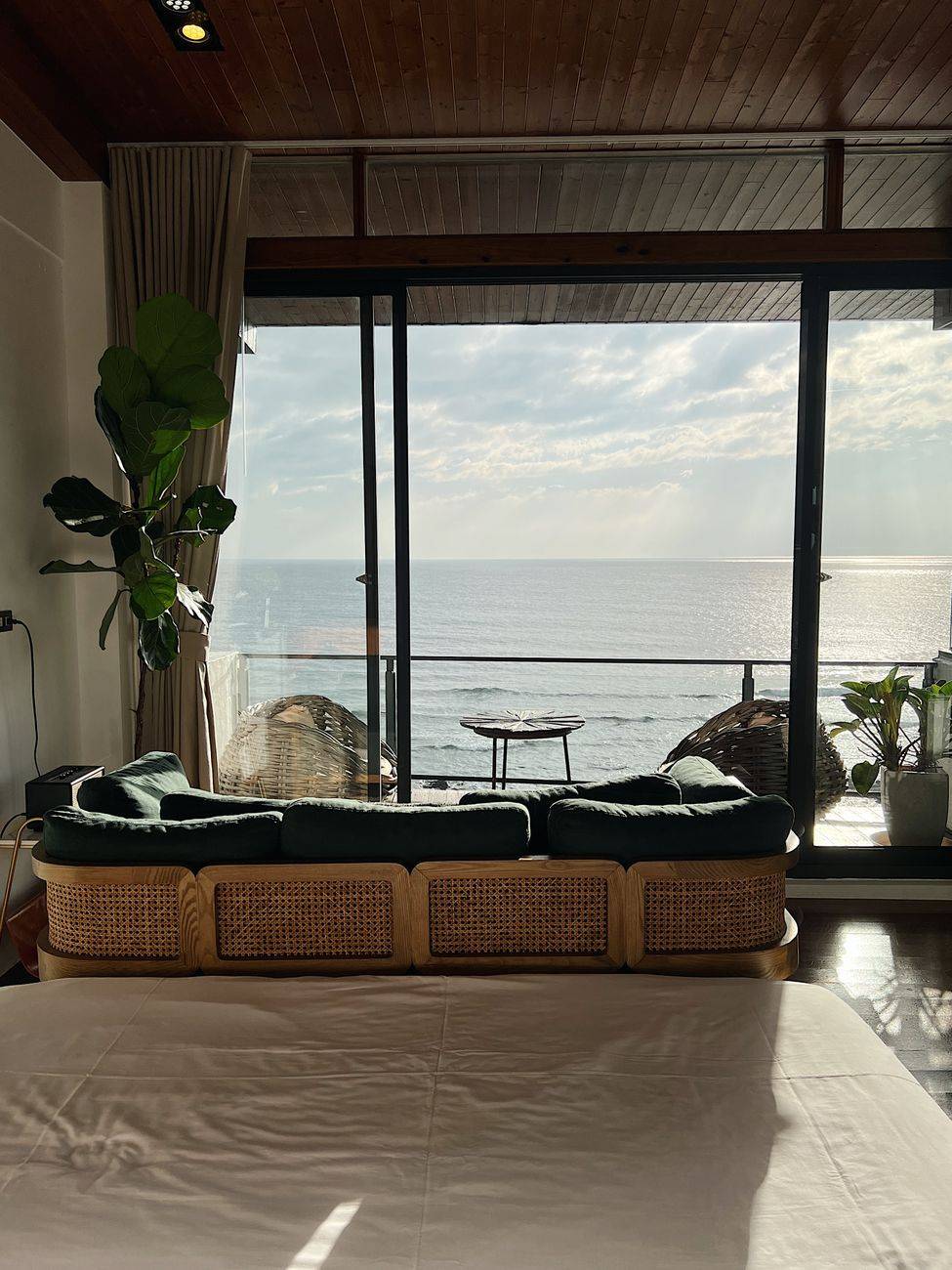 Cozy hotel room with a stunning ocean view and modern furnishings for a perfect summer getaway.