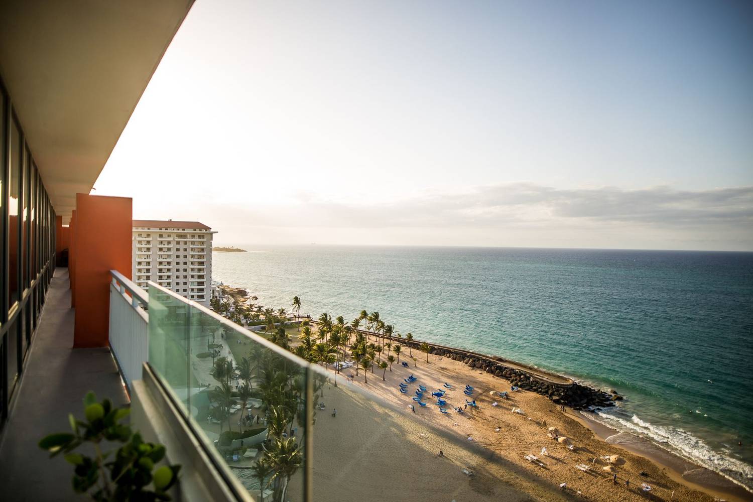 Breathtaking view of a tropical beach from a resort terrace overlooking the ocean during daytime.